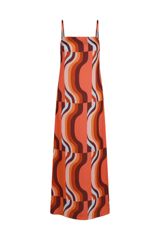 Model wearing the MISA Lark Dress in Retro Riviera featuring adjustable spaghetti straps, a straight neckline, colorful abstract satin print, and a flowing maxi silhouette.