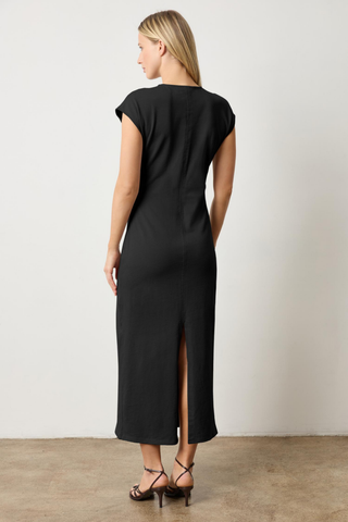Black cap sleeve V-neck maxi dress with side tuck detail and back slit by Lilla P worn with strappy heels
