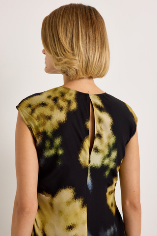 Marie Oliver Zuri Dress in Lush featuring oversized golden florals on a black background with a fluid sleeveless maxi silhouette.
