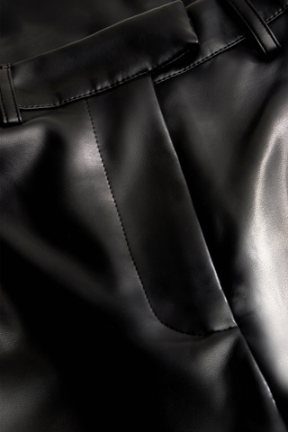 Marie Oliver Harlow Pant in Black featuring sleek vegan leather, a fitted waist, and modern barrel-leg silhouette.