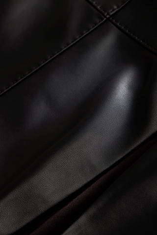 Crawford Skirt in Black featuring a fitted vegan leather mini silhouette with subtle pick stitching and a flared A-line hem.