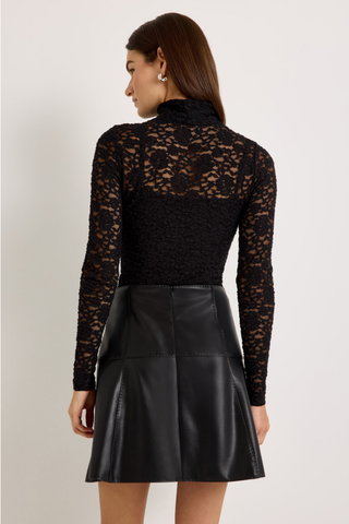 Crawford Skirt in Black featuring a fitted vegan leather mini silhouette with subtle pick stitching and a flared A-line hem.