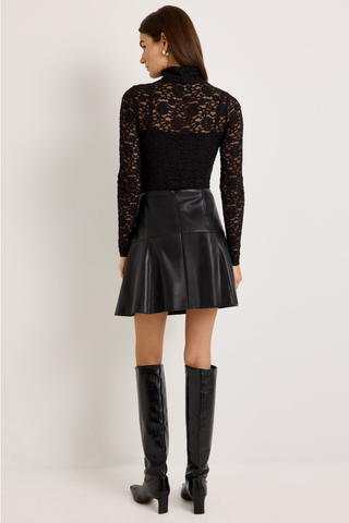 Crawford Skirt in Black featuring a fitted vegan leather mini silhouette with subtle pick stitching and a flared A-line hem.