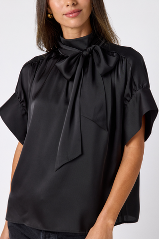 Crosby Lillian Top in Black featuring a high tie neckline, statement short sleeves, and relaxed blouse silhouette.