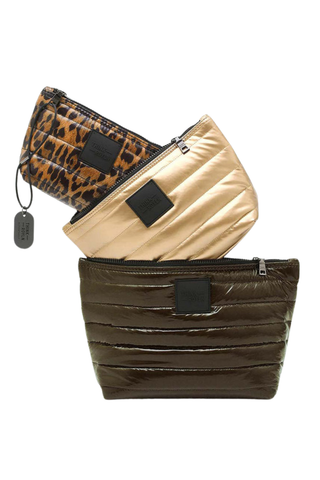 Think Royln Travel Trio set of three quilted pouches in chocolate brown, pearl, and leopard print.