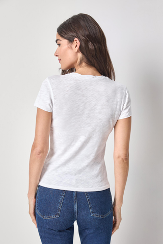 Model wearing the Lilla P Twisted Binding V-Neck Tee in White featuring lightweight textured slub cotton, a twisted V-neckline, and a flattering fitted silhouette.