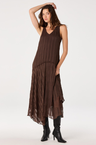 ASTR Halo Dress in Brown Plaid featuring a V-neckline, drop waist, and flowing asymmetric maxi hem.