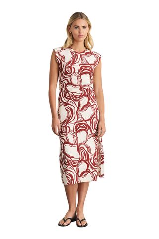 Woman wearing a red and white patterned dress on a white background