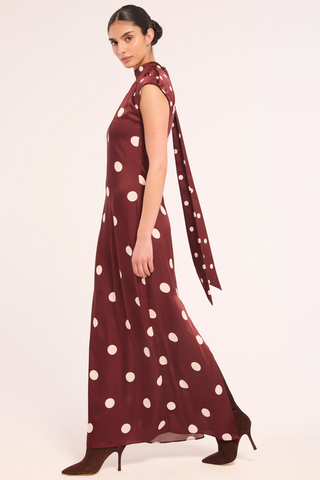 Misa Runi Dress in Polka Dots Mix featuring burgundy satin with oversized cream polka dots, a gathered high neckline, and a contrasting tie-back sash.