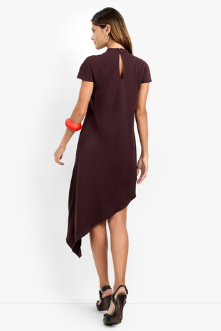 Trina Turk Shana 2 Dress in Cioccolato featuring a high neckline, short sleeves, and flowing asymmetrical midi hem.