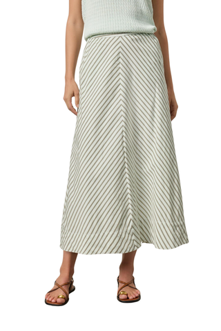 Model wearing the Lilla P Stripe Maxi Skirt in Pool Stripe featuring a soft diagonal stripe pattern, maxi length, flowing A-line silhouette, and lightweight fabric paired with flat sandals