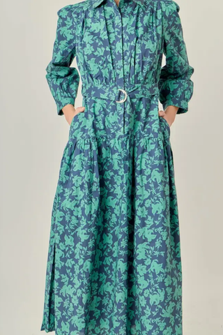 Green and blue patterned dress on a plain background