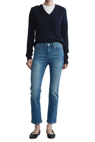 Model wearing the DL1961 Mara Straight Ankle Jean in Crisp Air with a mid-rise straight-leg silhouette.