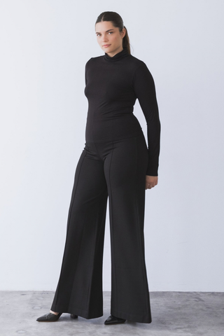 Ripley Rader Modal Turtleneck in Black featuring a fitted body-skimming silhouette, high neckline, and extra-long sleeves.