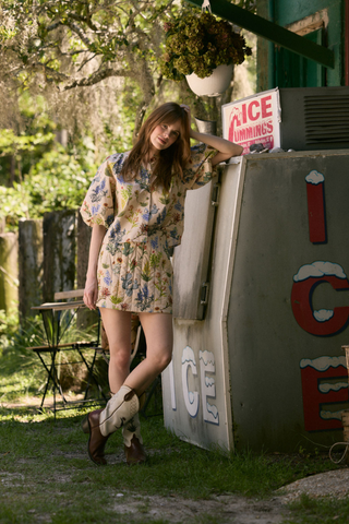 Olivia by Livro Delia Skirt in Chaparral featuring a relaxed mini silhouette and floral print.