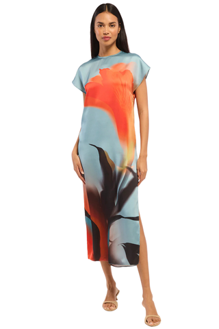 Model wearing the MISA Lenna Dress in Fire Petal featuring a high neckline, cap sleeves, abstract satin print, and elegant midi column silhouette.