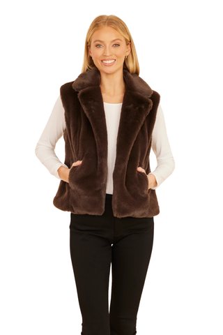 Dolce Cabo Faux Fur Vest in Dark Brown featuring plush chocolate brown faux fur, a notch collar, open front, and side pockets.