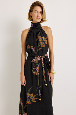 Penelope Dress in Nightshade featuring a black floral maxi silhouette, halter neckline, fluid A-line skirt, and optional sash belt.