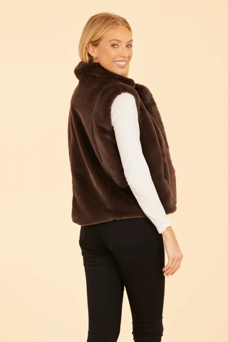 Dolce Cabo Faux Fur Vest in Dark Brown featuring plush chocolate brown faux fur, a notch collar, open front, and side pockets.