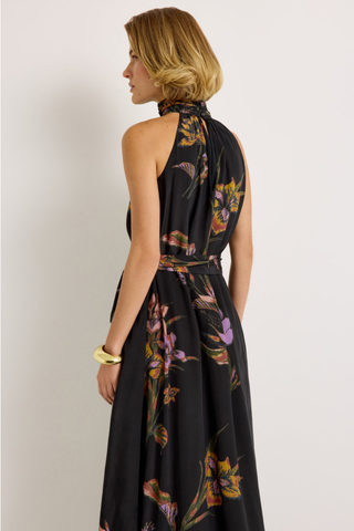 Penelope Dress in Nightshade featuring a black floral maxi silhouette, halter neckline, fluid A-line skirt, and optional sash belt.