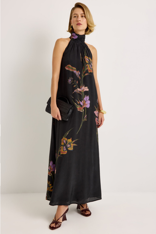 Penelope Dress in Nightshade featuring a black floral maxi silhouette, halter neckline, fluid A-line skirt, and optional sash belt.