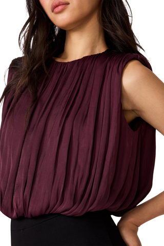 Steve Madden Milana Top in Purple Wine, a sleeveless burgundy blouse with gathered detailing and a relaxed silhouette.