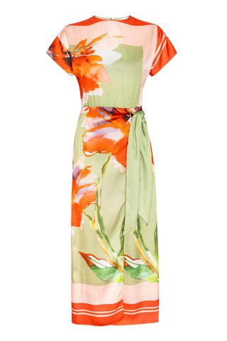 Model wearing the MISA Devorah Dress in Scarf Flora Satin featuring a vibrant floral print, satin fabric, side tie wrap detail, high neckline, and midi length silhouette