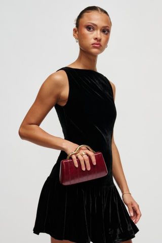 Rue Aveline Nichelle Clutch in Burgundy featuring textured vegan leather, a structured frame silhouette, gold-tone top handle, and removable chain strap.