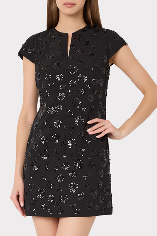 Milly Pat Sequin Mini Dress in Black featuring floral sequin embellishments, a notched V-neckline, short sleeves, and a shift silhouette.