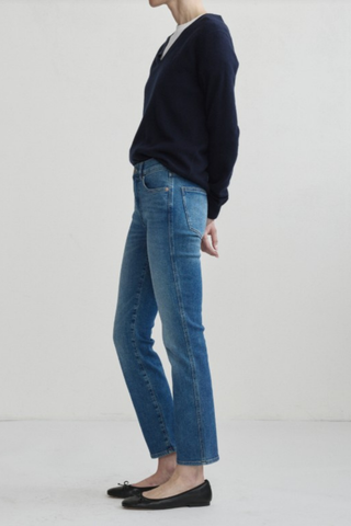 Model wearing the DL1961 Mara Straight Ankle Jean in Crisp Air with a mid-rise straight-leg silhouette.