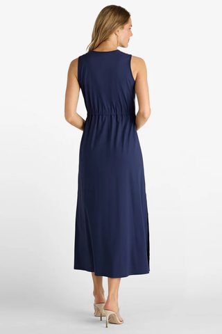 Woman wearing a navy blue sleeveless dress on a white background