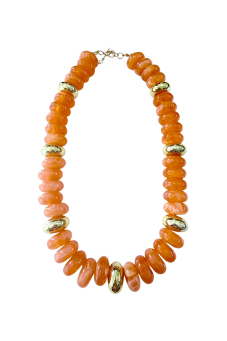 Gemelli Rowell Beaded Disc Necklace in Orange featuring glossy orange disc beads, contrasting green accents, and gold-tone hardware.