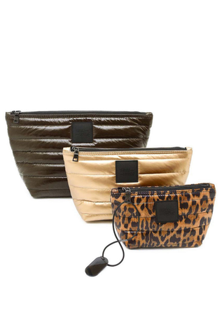 Think Royln Travel Trio set of three quilted pouches in chocolate brown, pearl, and leopard print.