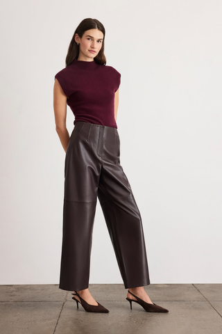 Tanya Taylor Adrien Cashmere Turtleneck in Blackberry featuring a fitted sleeveless-style silhouette with cap sleeves and a refined mock neckline.
