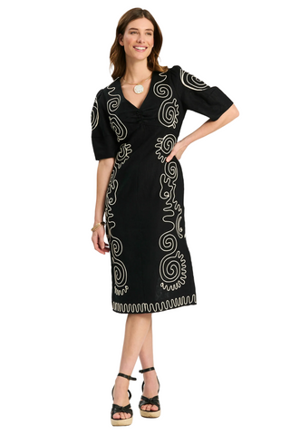 Model wearing Tyler Boe Posey Linen Midi Dress in black linen with white contrast embroidery, lantern sleeves, and midi silhouette