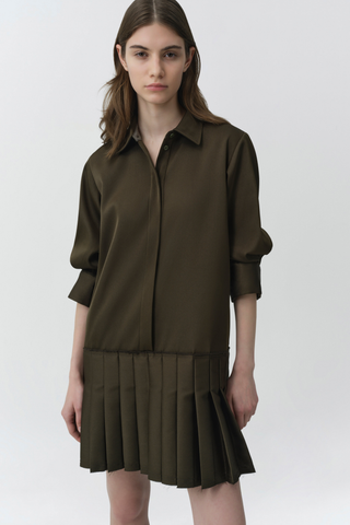 SIMKHAI Regina Mini Dress in dark olive featuring a pointed collar, short puff sleeves, concealed button front, and pleated mini hem.