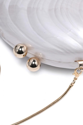 Urban Expressions Robyn Evening Bag in Ivory featuring a pearlescent marbled acrylic half-moon silhouette, gold-tone kiss-lock clasp, and detachable chain strap.