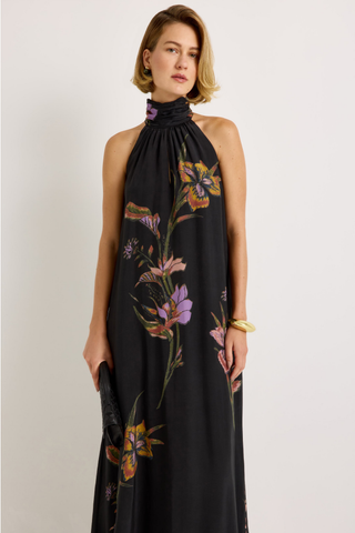 Penelope Dress in Nightshade featuring a black floral maxi silhouette, halter neckline, fluid A-line skirt, and optional sash belt.