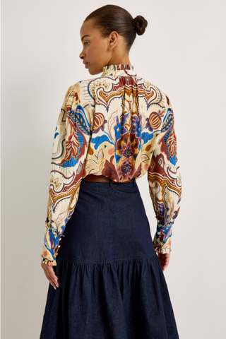 Montana Blouse in Rodeo featuring a colorful Western-inspired print, button front, ruffled collar and cuffs, and voluminous long sleeves.
