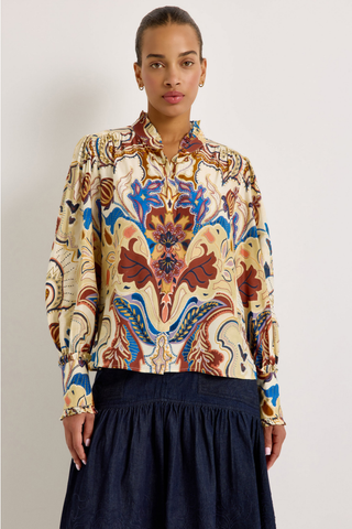 Montana Blouse in Rodeo featuring a colorful Western-inspired print, button front, ruffled collar and cuffs, and voluminous long sleeves.