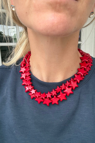 Smith & Co. Design Small Star Necklace in Red featuring vibrant red 15mm star-shaped beads and a lobster clasp closure.