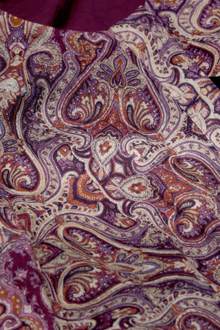 Marie Oliver Hughes Dress in Wisteria featuring a purple paisley print, long sleeves, patch pockets, and optional waist belt.