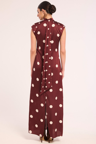 Misa Runi Dress in Polka Dots Mix featuring burgundy satin with oversized cream polka dots, a gathered high neckline, and a contrasting tie-back sash.