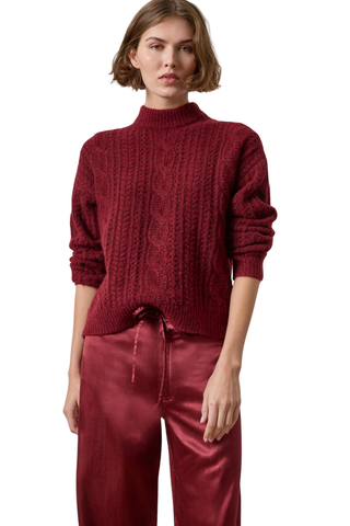 Woman wearing the Lilla P Relaxed Cable Knit Sweater in Port, a burgundy cable-knit crewneck sweater.