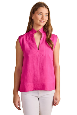 Model wearing the Double A Sandy Top in Fuchsia featuring a sleeveless silhouette, stand collar, split neckline, and relaxed fit paired with white denim