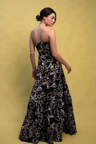 Strapless black printed formal gown with a structured bodice and full skirt.