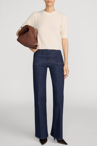 FRAME Le Slim Palazzo Pintuck Pocket jeans in dark Rinse wash with a high-rise waist, front patch pockets, pintuck seams, and wide-leg silhouette.