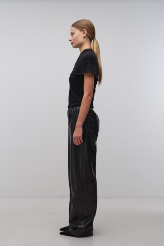 Black cape-style top with a modern tailored silhouette.