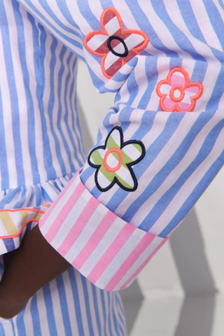 Celia B Avra Jacket in Multi featuring blue and white stripes, colorful embroidered floral details, puff sleeves, and ruffle hem styling
