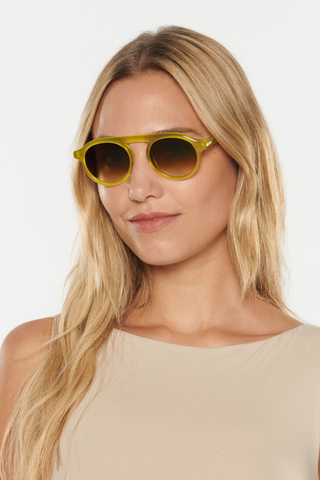 KREWE Cameron Sunglasses in Chartreuse featuring a rounded aviator silhouette, connected brow bar, translucent acetate frame, and brown gradient lenses